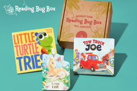 Colorful children's books featuring animals and vehicles with a Reading Bug Box subscription box for kids