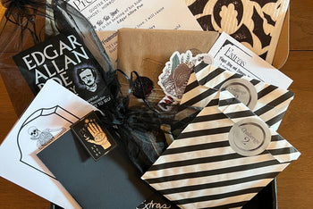 Our Halloween box was gothic inspired with a new book, Poe- post its, pocket notebook and several wrapped gifts. 