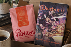 Mistborn: The Final Empire by Brandon Sanderson with Elevate coffee blend in a hardcover fantasy book subscription box