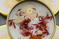 Litha Sabbat Candle from the Busy Witch Box featuring saffron, citrine, and a sun charm in a gold tin