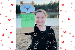 Happy child withFebruary Valentine's box with 20 OT activities, crafts, sensory materials, and fine motor tools for ages 4+ February Activit