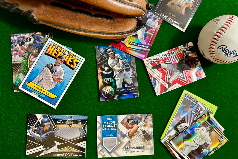 New York Yankees baseball cards arranged in flat lay format with a baseball glove and ball around them