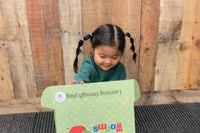 Happy child excitedly showing off a Wiggle Worms Kit, filled with creative crafting supplies........