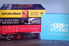 Brown subscription box filled with four surprise mystery books, featuring captivating stories and intriguing plots for genre enthusiasts.