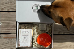 Box includes: 
one full-size  12oz bag of coffee , 
a themed lagniappe gift for the human 
and a sample treat for your furry friend