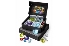 Open GemFlip mystery gemstone box displaying multiple compartments with rough and faceted natural gemstones, presented in a premium black bo