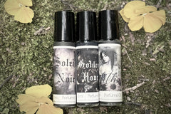 Muse Fragrances by SugarMuses® nestled in a small black box packed with organic moss and other botanicals.