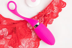 Colorful items including a pink dual-head vibrator and massage oils in the Woman SOLO Adult Subscription Box for self exploration