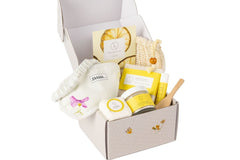 All-natural bath and body gift box with citrus-scented skincare products, including soap, body oil, body scrub, shower steamer mist, facial 