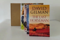 Brown box filled with a diverse collection of books in multiple genres, including crime thrillers, romance, and fantasy