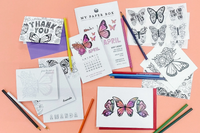 Butterfly-themed stationery flat lay with coloring pages, thank-you cards, and pencils from My Paper Box April “Butterfly Blooms” collection