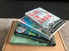Brown box filled with crime thriller books, showcasing a variety of gripping titles and intriguing covers, perfect for mystery lovers.
