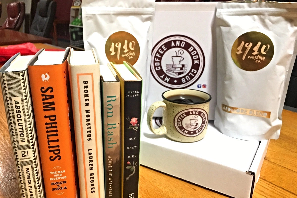 A set of 5 books alongside a mug of coffee