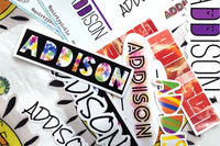 Examples of a subscriber's personalized name stickers in several different original and colorful designs, showing the name "Addison"