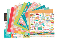 Colorful scrapbook papers and stickers in a monthly scrapbook kit featuring floral designs and cameras, ideal gifts for women