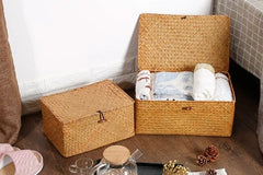 Handmade seagrass storage baskets filled with towels and linens, with potpourri and slippers and glass jars