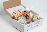 The "Sweet Georgia Peach" box opened to showcase taffy, peanut butter, dish towel and hot sauce along with other products.