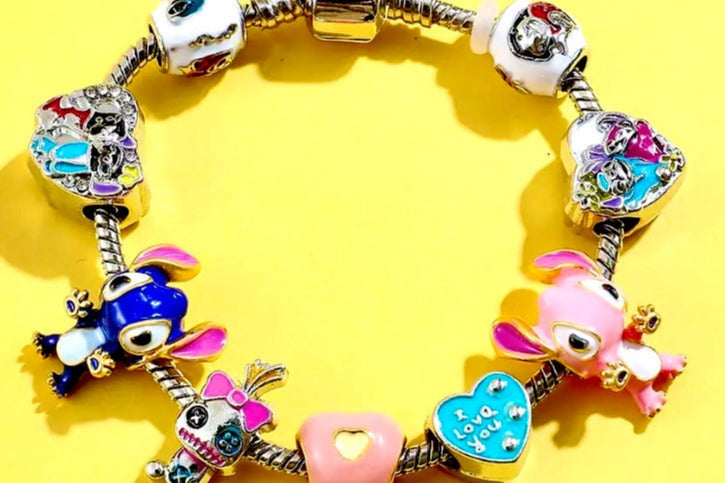 Lilo and Stitch 2024 vintage silver snake charm bracelet with bold, bright hand-detailed charms on a vivid yellow background.