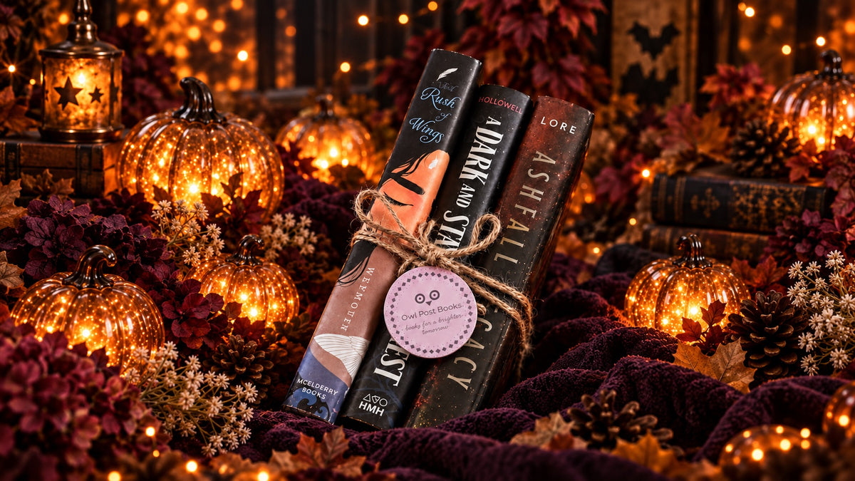 Owl Post Books fall reads tied with twine among glowing pumpkins