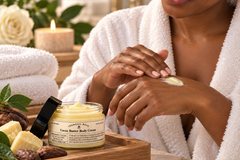 Woman enjoying Tranquil Rose body butter during a relaxing spa experience with soft towels, flowers and natural bath accents.
