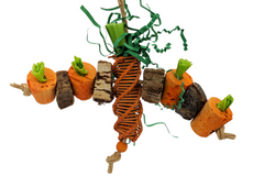 A carrot themed bird toy made of corks, mahogany slices, vine, and papers. Colors are orange and green. Shown on a white background. 