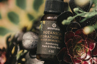 High quality closeup photo of an oil drop skin care product. The whole background is covered by wild flowers.