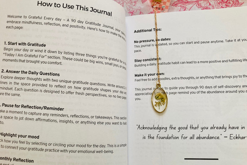 Open pages of a 90-day wellness and mindfulness  journal featuring daily prompts and calming designs to inspire self-care and reflect