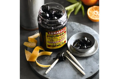 Luxury cocktail cherries in a glass jar, perfect for garnishing classic cocktails like the Old Fashioned