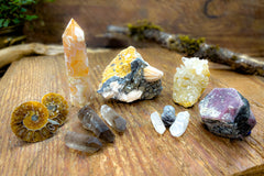 Enchanted Crystal subscription box on wooden table, with multiple crystals arranged and bonus mini crystals