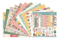 Colorful scrapbook papers and stickers in a monthly scrapbook kit featuring floral designs and cameras, ideal gifts for women