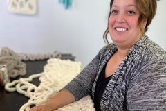 Woman enjoying making a chunky knit blanket | Panache Craft Box - Monthly Craft Box + Live Virtual Art Class 