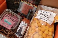 Hot Stuff spicy food snacks like hot sauce, chamoy candy, fin a box  showing example   of the products that can be included in our spicy box