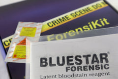 A blue box containing a forensikit is displayed in the back while blood detecting luminol is in the foreground