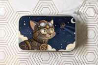 Outside label of one of the catnip tin variants. Featuring a steampunk dressed cat looking into the starry night sky.