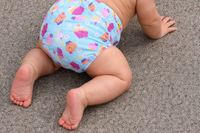 Baby crawling while wearing cupcake cloth diaper.