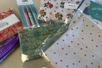 Each box is filled with high quality cotton fabric, a pattern and notions to complete the projects.  There is extra in each box.