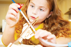 Child building BrainStorm Rocketry STEM Kit.