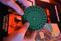 A cipher wheel from one of the murder mystery games with escape room puzzles from The Deadbolt Mystery Society.