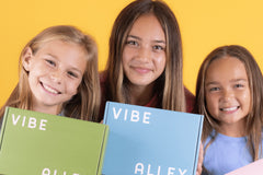 Colorful Vibe Alley Monthly Box for Teen and Tween Girls with festive decorations and ribbons, ideal gift box for tween girls