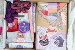 Blind date with a book wrapped in color papers with annotation supplies, bookmarks, book log, bookish stickers and sticker tabs