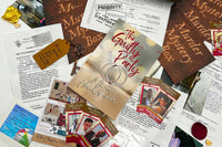 Sample of one of our previously released mysteries The Guilty Party shown on a table with the journal, evidence, and clues on a table.