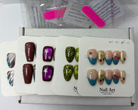Assorted press-on nail sets laid out in packaging trays, featuring different colors and patterns including solids, stars, and textured desig