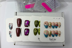 Assorted press-on nail sets laid out in packaging trays, featuring different colors and patterns including solids, stars, and textured desig