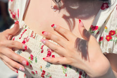 Set: Cherrylicious. Almond shaped medium length nails with nude pink and white base. 3D cherries. Pink bows and rhinestones. Red french tip