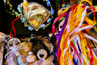 Beltane-themed Busy Witch Box featuring a DIY flower crown, ribbon wands, ritual bath blend, and anointing oil in a subscription box