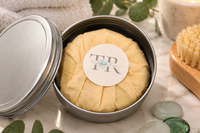 Tranquil Rose handcrafted soap stored in a reusable travel tin, offering convenient protection for soap at home or while traveling.