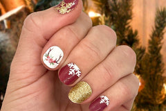 styled nail wraps displaying snowflakes, antlers, roses and featuring white, red, gold and brown colors