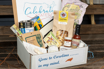 A busting box to showcase the state of North Carolina. This box included locally made food items, and an insulated drinking cup.