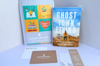 Ghost Town Living book displayed next to branded packaging, bookmarks, and cards from the You Should Read box.