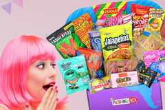 Pachanga Box featuring the snacks from El Salvador with a woman admiring the box and all of the snacks included with a pink background. 